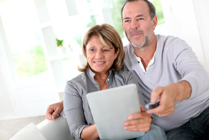 Older Couple Watching TV While using a Tablet Computer