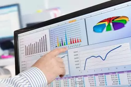 Man's hand pointing at analytics data charts