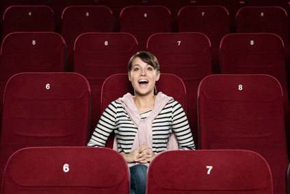 Young woman watching a fun scene of the comedy