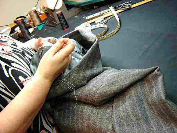 Woman sewing men's suit
