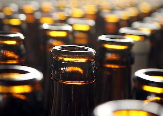 Photo of tops of beer bottles 